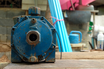 The front of the blue water pump is old condition with rust.