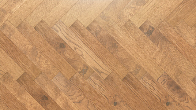 Light Wood Background. Wooden Boards arranged in a Herringbone Parquet Pattern.