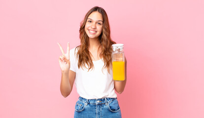 young pretty woman holding an orange juice