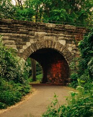Fototapeta na wymiar A path through a stone tunnel, Central Park, New York City