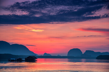 Obraz na płótnie Canvas Beautiful sky in the morning during sunrise at fisherman village of Sam-Chong-Tai, Phang-Nga province, Thailand.