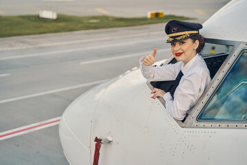 Airline pilot showing her readiness for take-off © Viacheslav Yakobchuk
