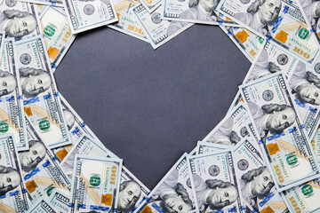 Heart shape in center of dollar money background from one hundred dollars - 443455192