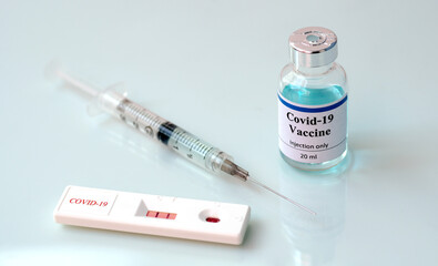 rapid test Coronavirus (covid-19) with vaccine bottle and syringe.