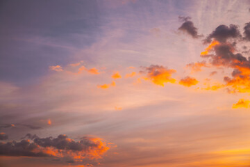 Sunset Cloudy Sky With Fluffy Clouds. Sunset Sky Natural Background. Sunrays, sunray, ray, Dramatic Sky. Sunset In Yellow, Orange, Pink Colors. Summer summertime background