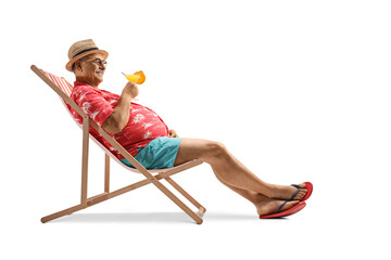 Mature male tourist enjoying on a chair with a cocktail