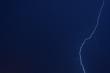 Thunderstorm. Lightning in the night blue sky