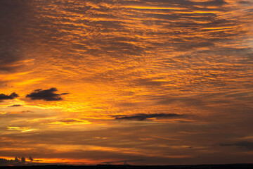 Dramatic fiery bloody sky. Fantastic golden sunset.