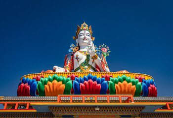 buddhist colorful goddess statue with flat blue sky at morning