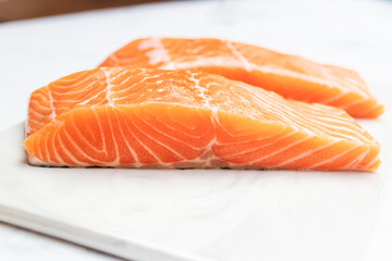 Fresh salmon fillet on marble plate for delicious salmon steak.