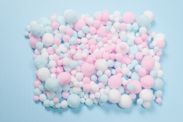 White, pink and blue soft pompons as a background.
