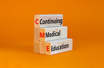 CME, continuing medical education symbol. Wooden blocks with words CME, continuing medical education on beautiful orange background. Business, CME, continuing medical education concept.