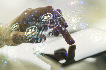 Double exposure of social network icons concept with world map and hand working with a digital tablet on background. Networking concept