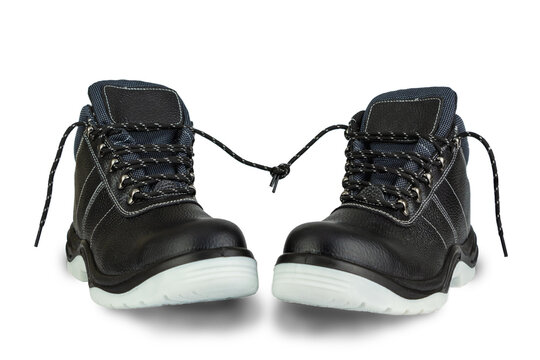 A pair of work boots with gray soles isolated on white background. The ends of the laces are tied. The boots are in the center and have a shade. The boots are facing each other. Romantic date concept.