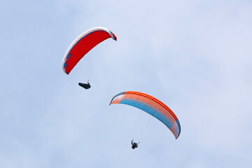 	
Paragliders in a blue sky	