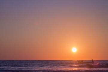 fisher boat at sunset