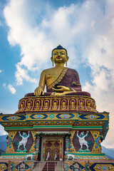 huge buddha golden statue from different perspective with bright blue sky at evening
