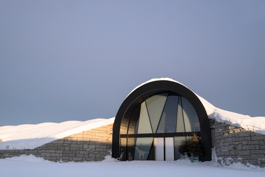 JUKKASJARVI, SWEDEN - MARCH 15 2020: Entrance to the Icebar and Icehotel 365 with ice stairs of the famous Ice hotel near Kiruna in Jukkasjarvi, Sweden with sunset