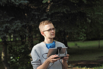 Drone pilot. Controlling the drone in the open air. High quality photo