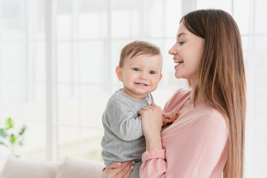 Happy caucasian mother holding her little small baby son daughter spending time together. Babysitter nanny embracing smill kid child. Motherhood adoption vitro IVF concept
