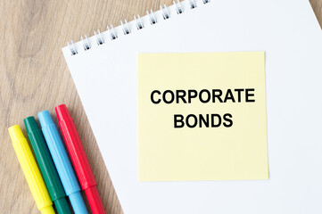 A yellow sticker with text Corporate Bonds is in a Notepad. Business and financial concept