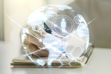 Social network media concept with world map and man hand writing in diary on background. Double exposure