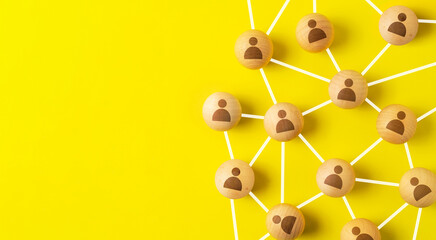 network and community concept,wooden ball connected together on yellow background - obrazy, fototapety, plakaty