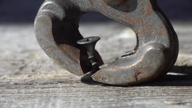 nail puller remove screw from wood. close up view macro closeup. High quality 4k footage