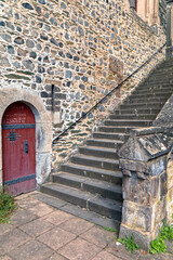 Old stone stairs with wooden door.