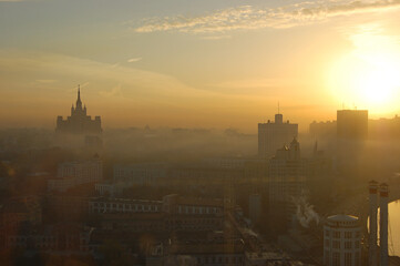 Yellow sunrise over hazy city of Moscow