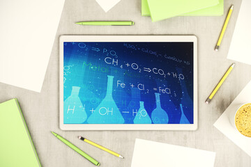 Creative chemistry illustration on modern digital tablet display, science and research concept. Top view. 3D Rendering