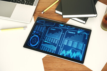 Modern digital tablet monitor with abstract statistics data hologram interface, computing and analytics concept. Top view. 3D Rendering