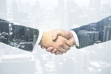 Handshake of two businessmen on modern cityscape background, deal and trading concept. Multiexposure