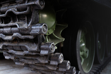Close-up view of caterpillar of the Soviet medium tank T-34. Fragment of a running gear of tank. Military industrial background. Selective focus