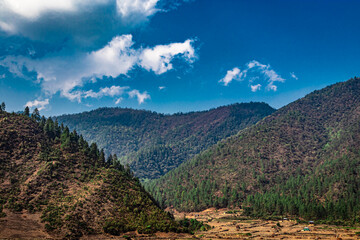 mountain valley with bright blue sky at morning from flat angle