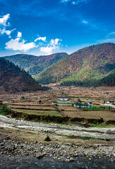 Fototapeta na wymiar mountain valley village with bright blue sky at morning from flat angle