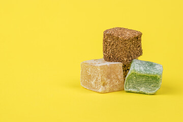 Three types of Turkish delight on a yellow background.