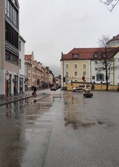Fototapeta na wymiar Streets in fussen germany. city ​​center in germany. rainy and cold day in a German town. typical German town. waiting for the bus. town in southern germany