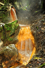 Nature hot spring with yellow sulphur color and steam 