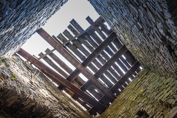 Wooden beams on the roof of the old tower in Kamianets-Podilskyi Castle under a cloudy grey sky. The fortress located among the picturesque nature in the historic city of Kamianets-Podilskyi, Ukraine