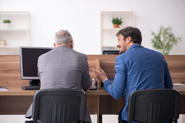 Two male employees working in the office