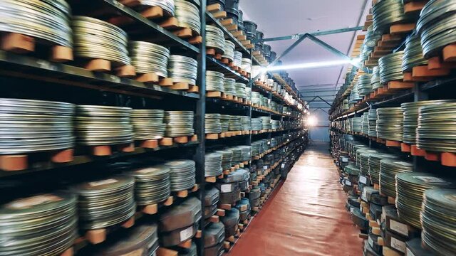 Retro, vintage technology concept. Movie cases on the shelves in the vintage cinema archive