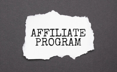 AFFILIATE PROGRAM sign on the torn paper on the black background
