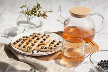 Homemade belgian waffles with berries and tea