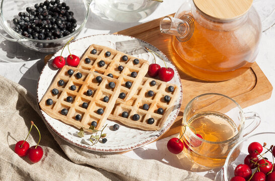 Homemade belgian waffles with berries and tea