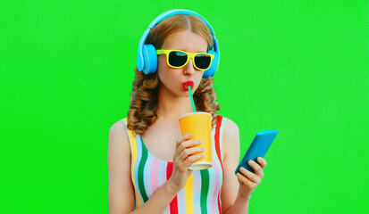 Summer colorful portrait of stylish young woman listening to music in headphones looking at...