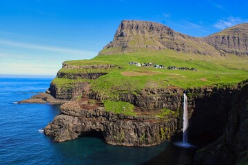 Múlafossur on Vagar Island, Faroe Islands on a beautiful day with clear sky in summer