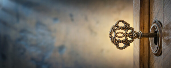Old key in keyhole, macro shot. Retro style. Key to knowledge. Concept and Idea for History, education, business, security, secret background.