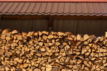 Laying firewood. A pile of logs. Stacks of firewood. Preparing for winter