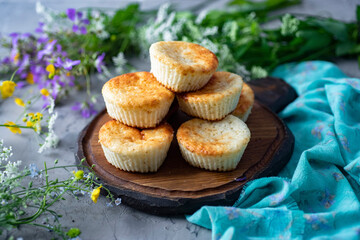 Cottage cheese pancakes with a banana on a beautiful plate on a gray background.